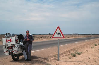Susan and BMW on road across Chott el Jerid, Tunisia