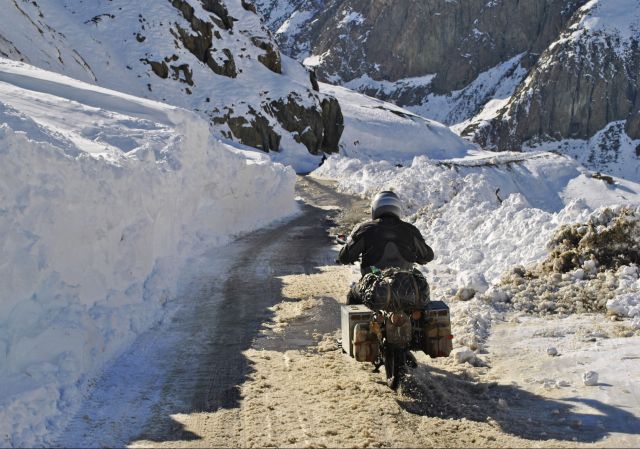 December: by Matt Kinch, Australia; of Bob Craen (Belgium), riding in unexpected snow on Zoji La Pass, Kashmir India; Royal Enfield 500cc.