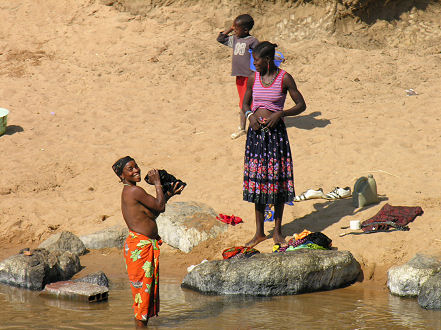 Ladies washing themselves and their clothes riverside