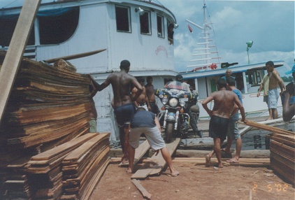 Unloading the bike from our boat, a timber carrier, at the timber yard