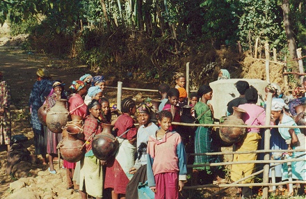 Women gathering water from the town well, still using clay pots
