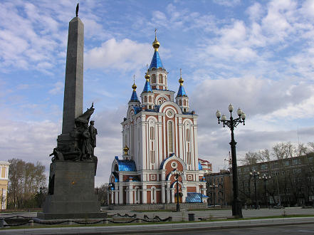 A new Russian Orthodox church in the old Soviet era plaza with its memorial statue