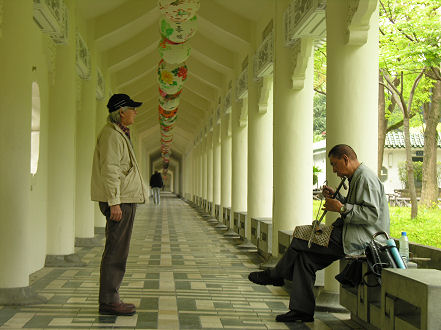 Elderly locals find a spot to play traditional instruments and sing