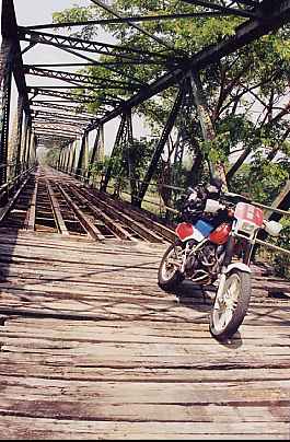 Honda on a wooden Thai bridge.