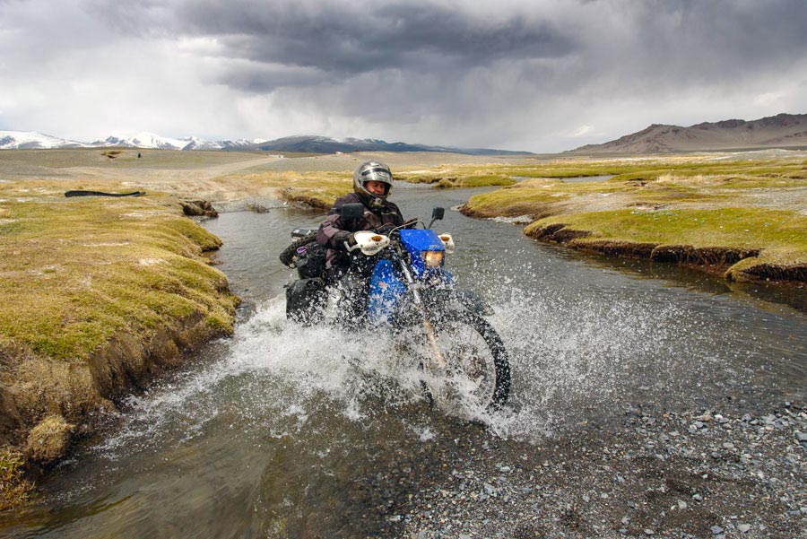 Photo by Stefan Thiel of Mark Hammond crossing a river in NW Mongolia