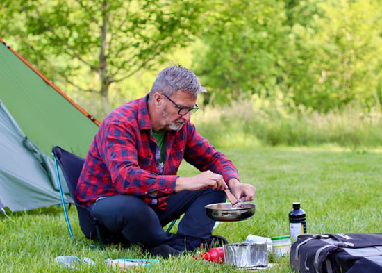 Arjan prepares a nutritous camp meal.