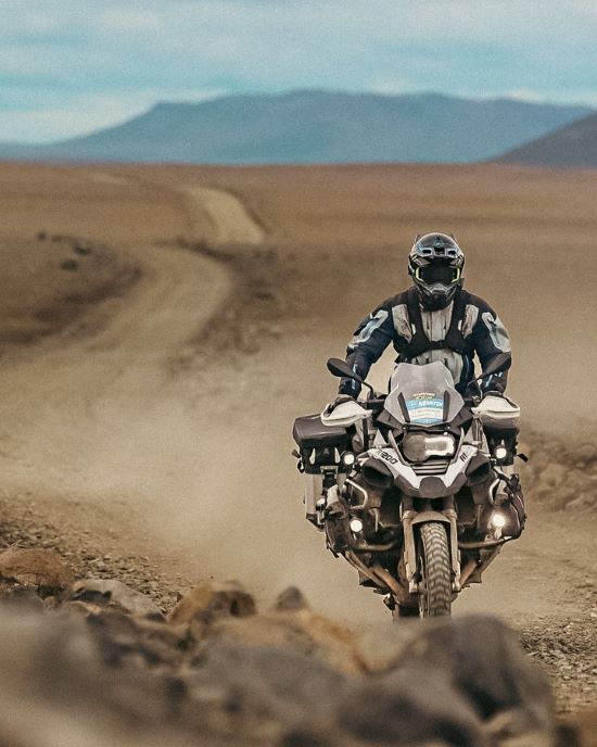 Martin Litschauer rides along a dusty, rocky road.