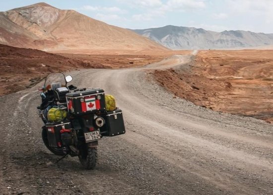 Lorry Gombos, Canadian motorcycle on dirt road.