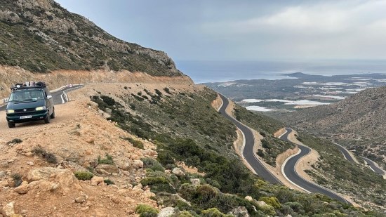 Van overlooking a vista with twisty roads.