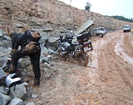 Notice the mud on the backside of Mr. BMW BBQ.  Also note the saddlebag sitting on the ground.