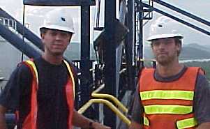 Dan and Ryan high atop container unloading cranes at the Panama Ports Company, Panama, overlooking the Panama Canal