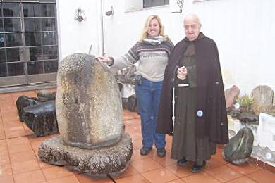 The Franciscan Padre, who has worked at this museum (in La Rioja) for over 40 years, showing Jules the pre-Inca grinding stone for extracting copper.
