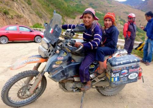 Peruvian children on bike.